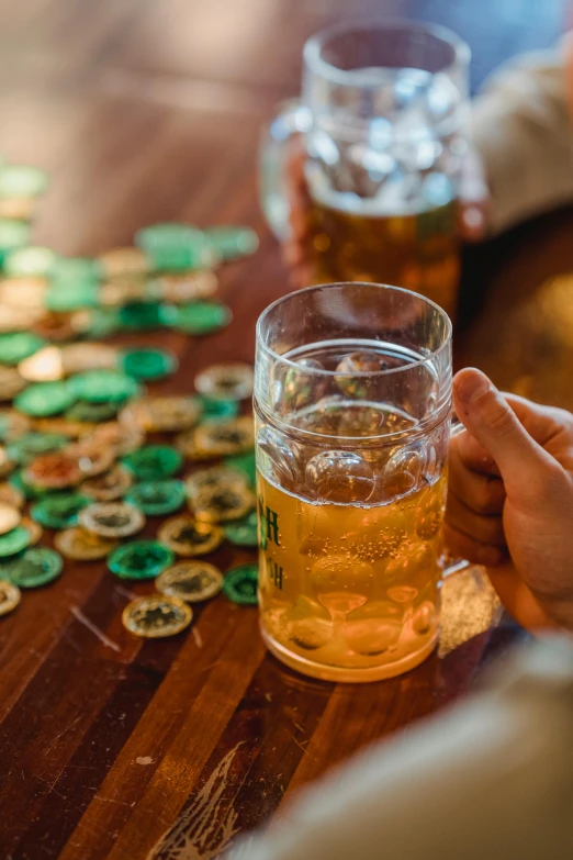 a beer being poured into a glass on a table