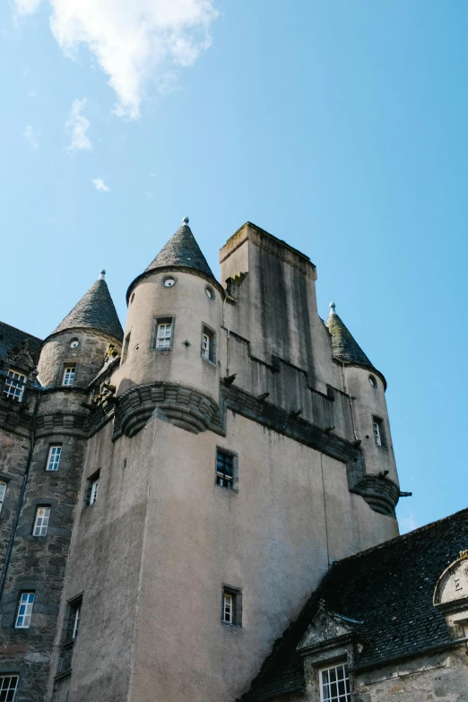 an old castle on top of a hill against the sky