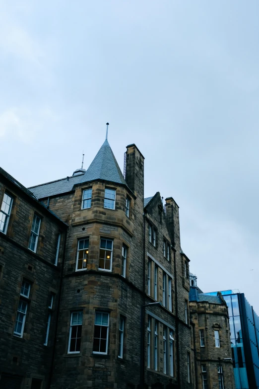 an old stone building with a clock at the top