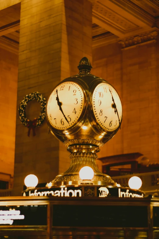 two clocks set to four o'clock, next to a wreath