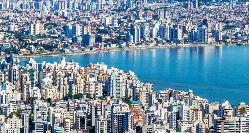 large buildings line the water front of a city