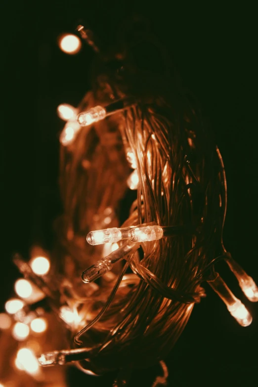 a string of christmas lights on black background