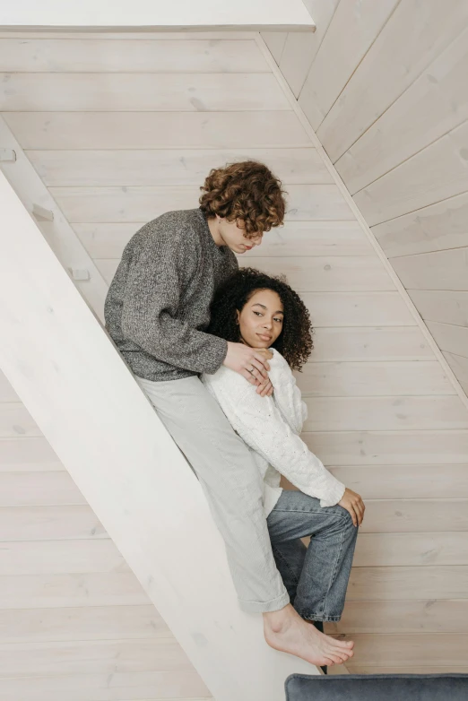 a man standing next to a woman on top of a stair