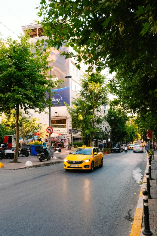 a street lined with parked yellow cars in a city