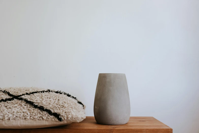 two modern vases sitting on a table next to each other