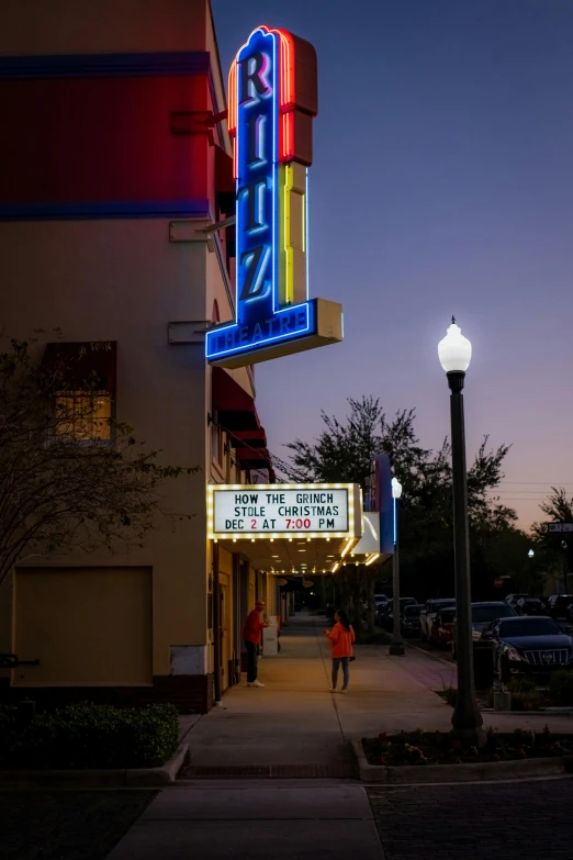 the sign is bright and colorful at night