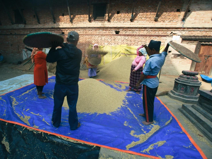 a man and woman are standing in an outdoor space with sand