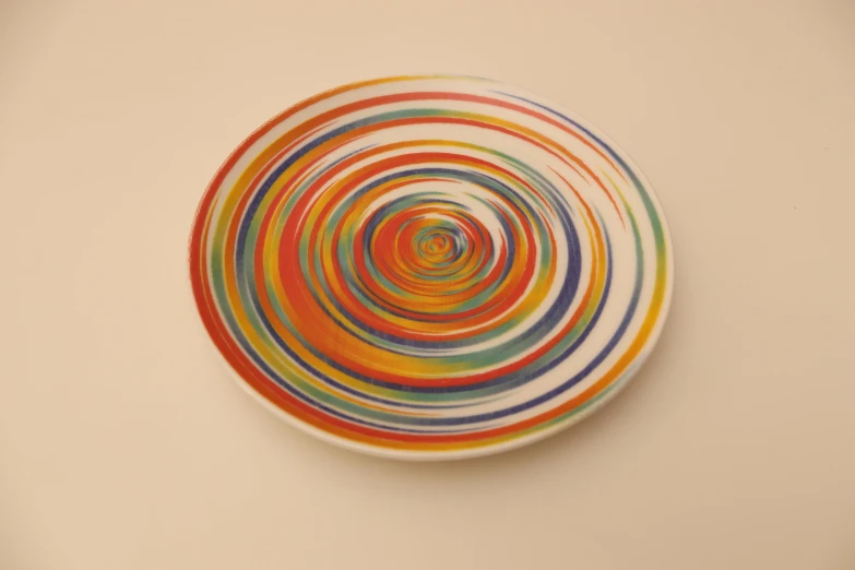 a plate with multicolored circles is on a wall