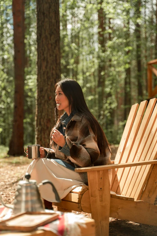 a woman is eating outside with a blanket