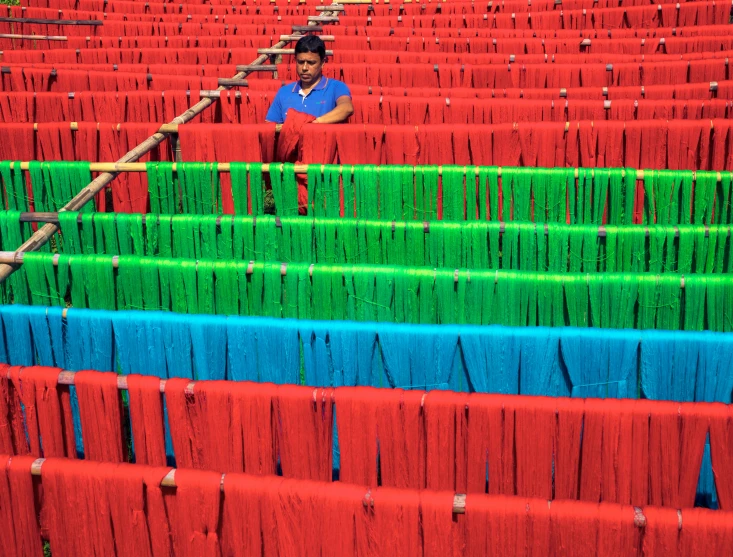 an asian man working at a textile fabric factory