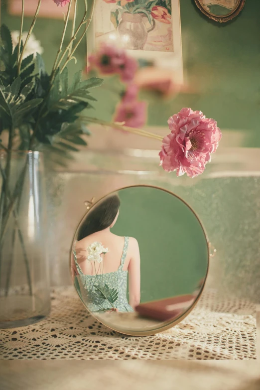 a woman is reflected in a mirror and flowers