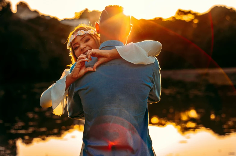 the young man and the woman have fun in front of the water