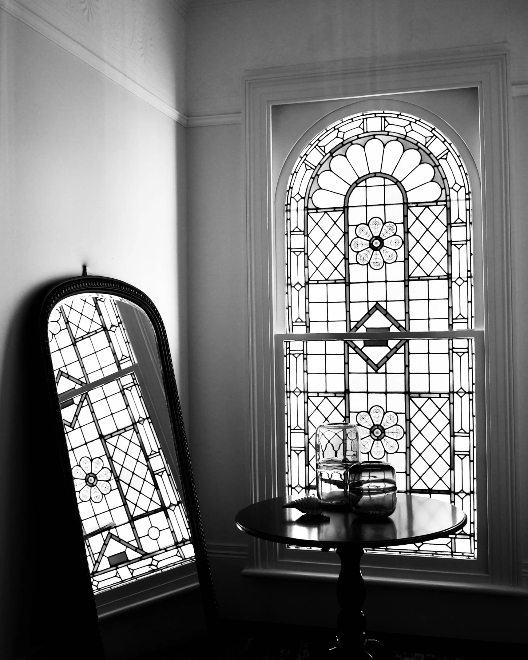 a table with a clock is by a window