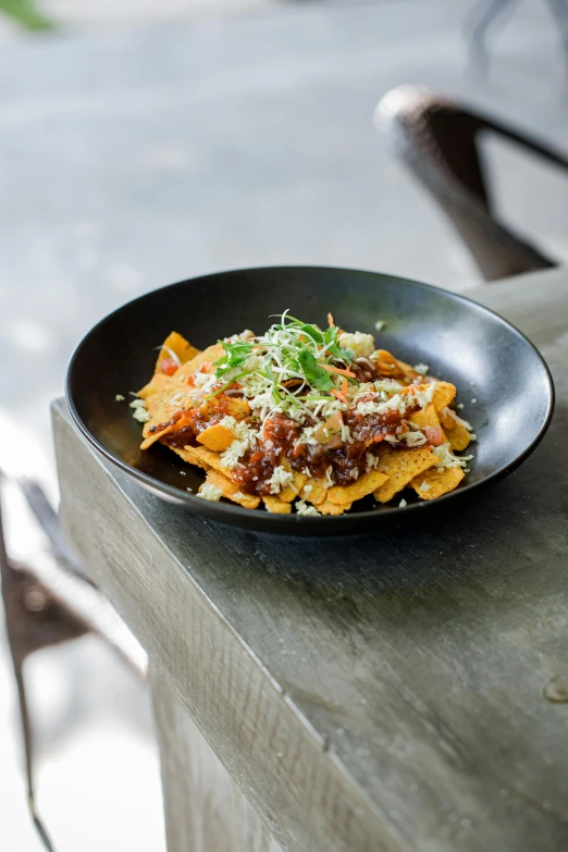 a bowl filled with lots of food sitting on top of a table