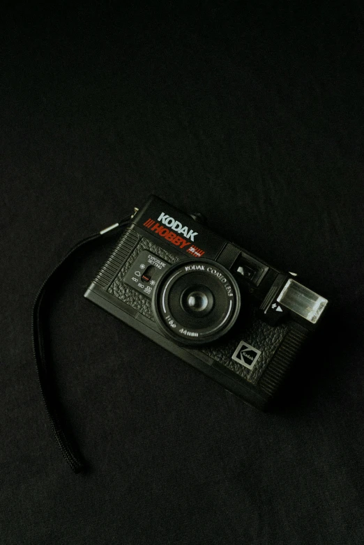 a digital camera is sitting on the black table