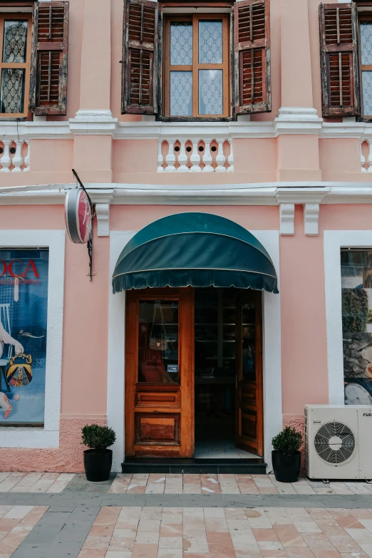 an old fashion shop in a pink building