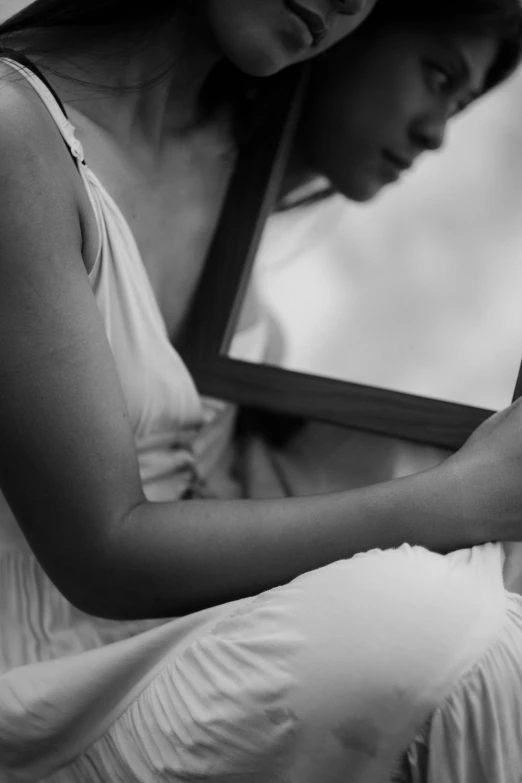 a beautiful woman in a white dress holding a phone