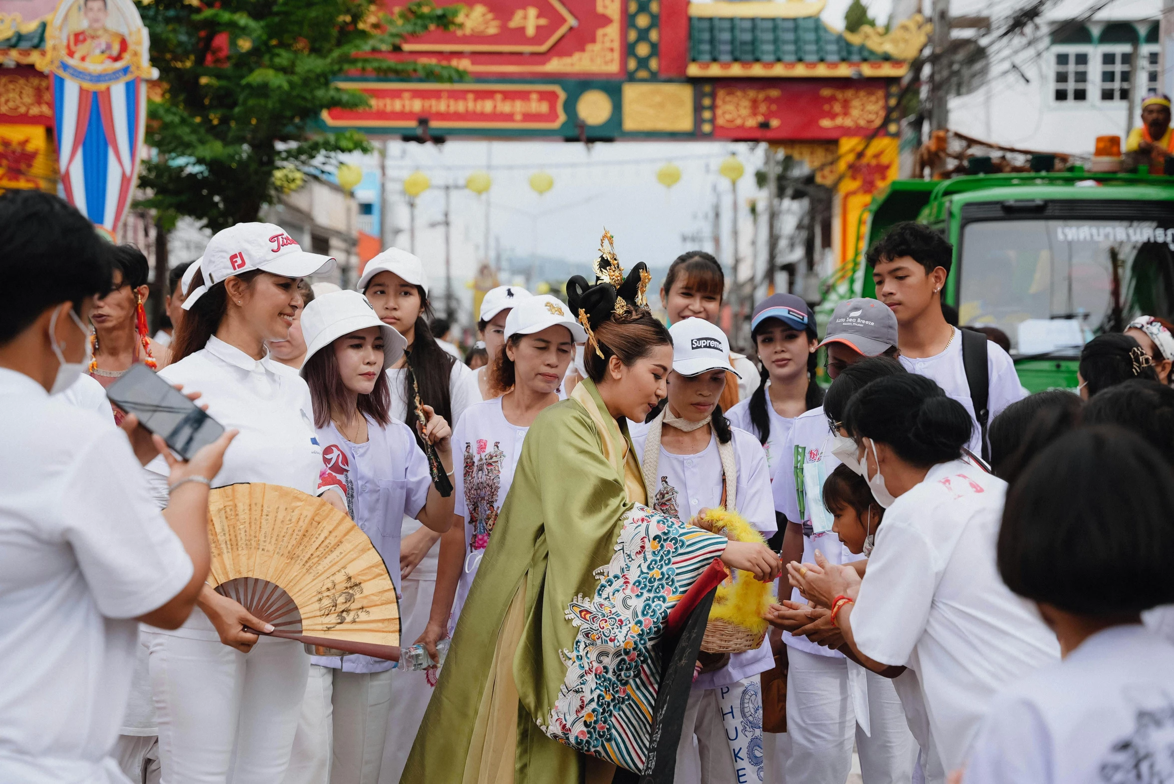 a group of women holding fans and looking at soing