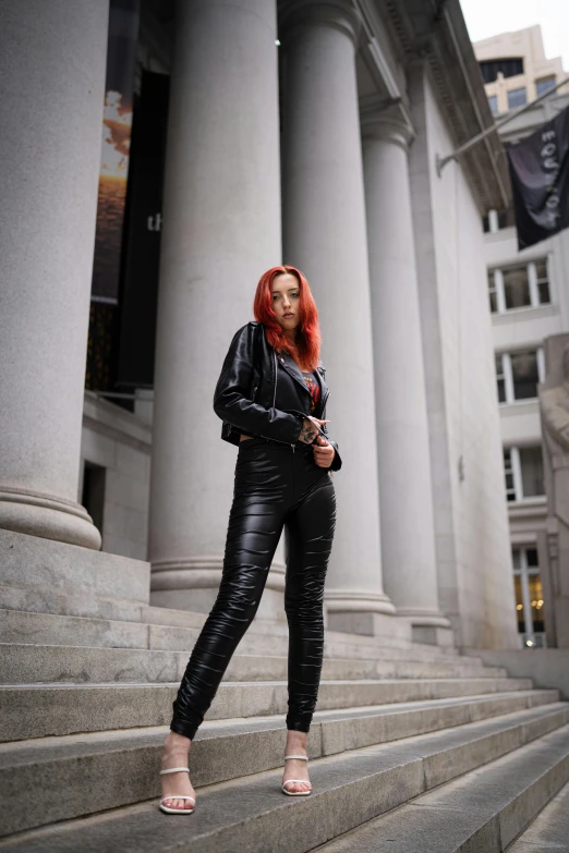 a woman posing in front of some steps