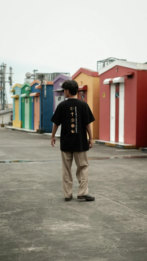 a man with a skateboard walking through the parking lot