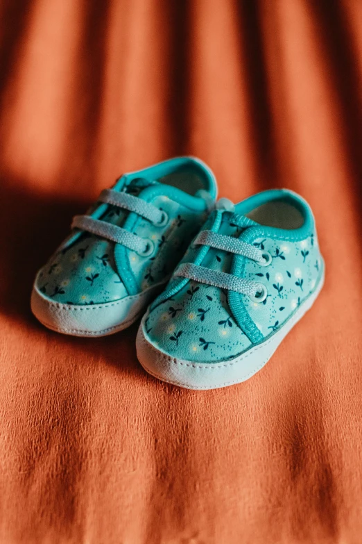 a pair of blue shoes with a small star and moon on it