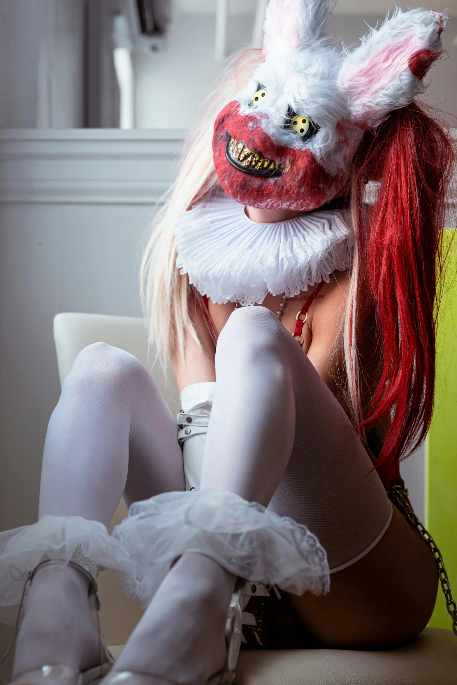 a woman with rabbit mask in white with a red hair