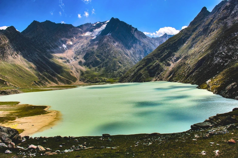 a lake sits among some mountain peaks