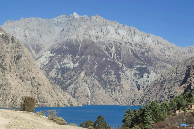 mountains are covered in snow near the water