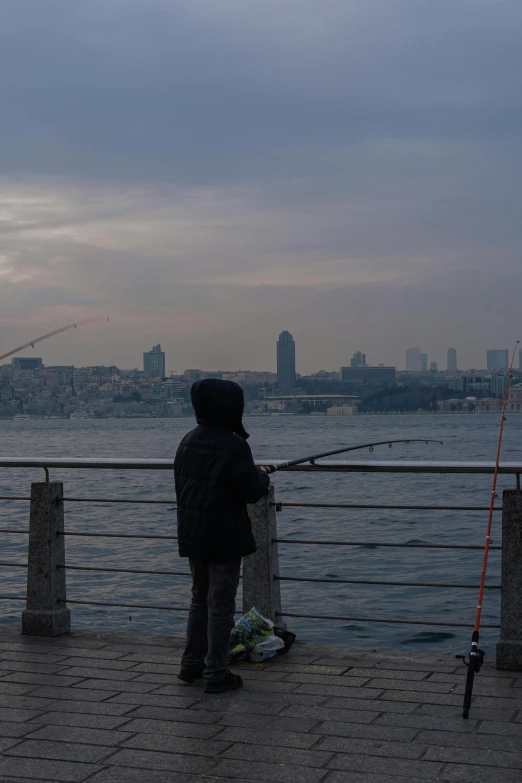 a man is fishing on the pier by himself