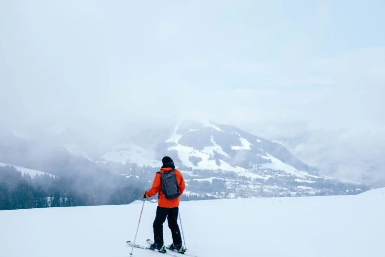 person on skies is looking towards a mountain