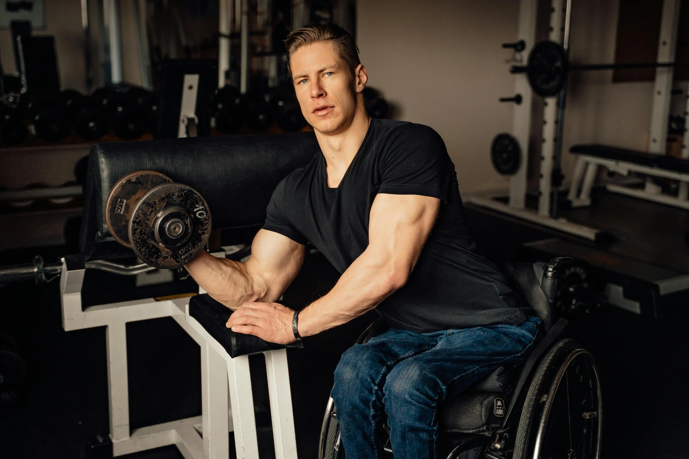 the man is squatting down and lifting a barbell