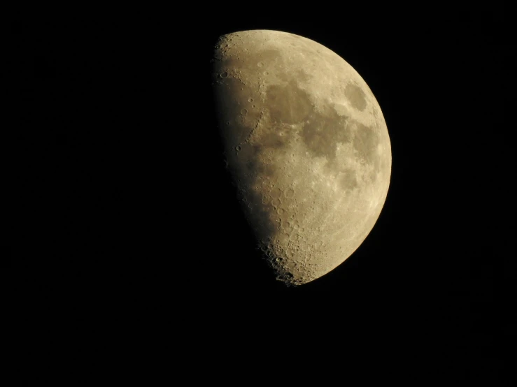 the moon appears to be half of an oval shaped object