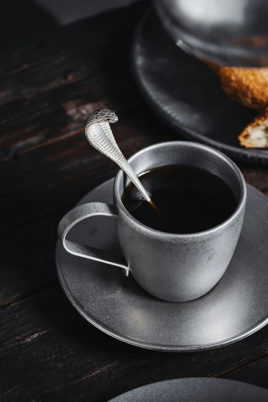 a coffee cup with a toothbrush resting in it