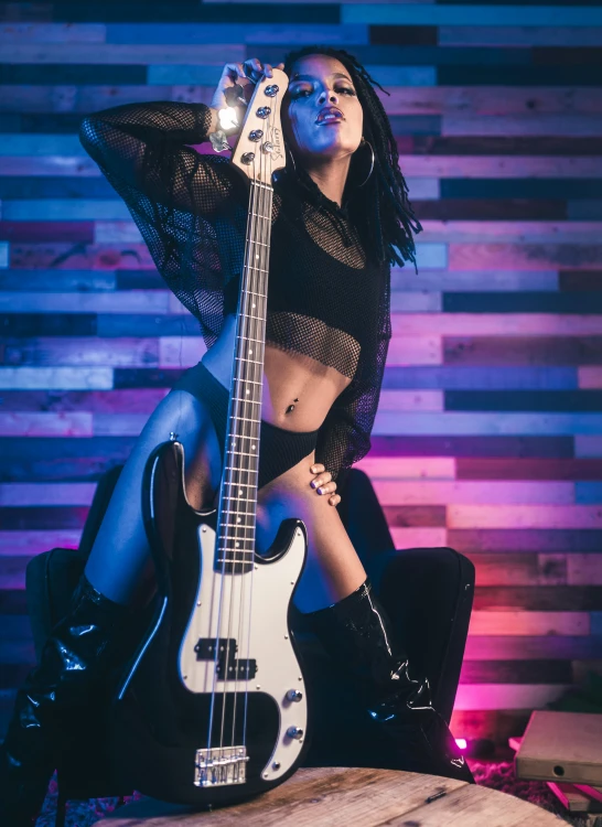 a beautiful woman with very high heels posing with a guitar