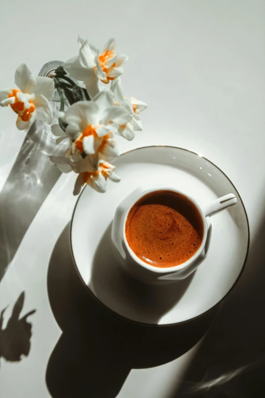 small white bowl of soup on saucer with flowers