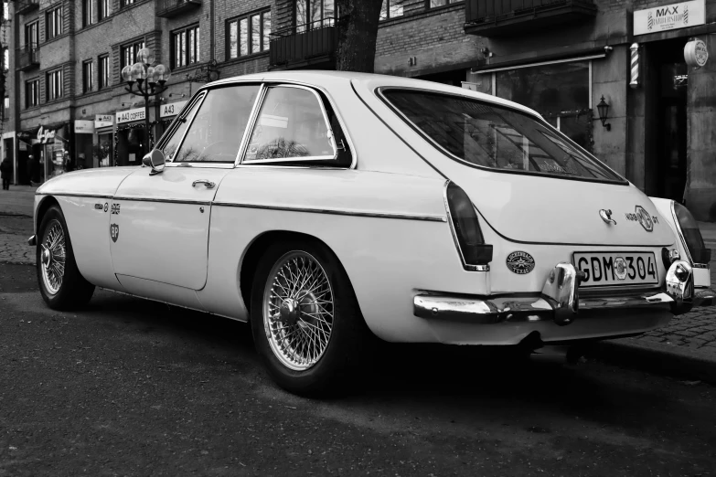 a white car parked in front of a building