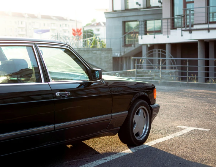 a black mercedes benz parked outside a building