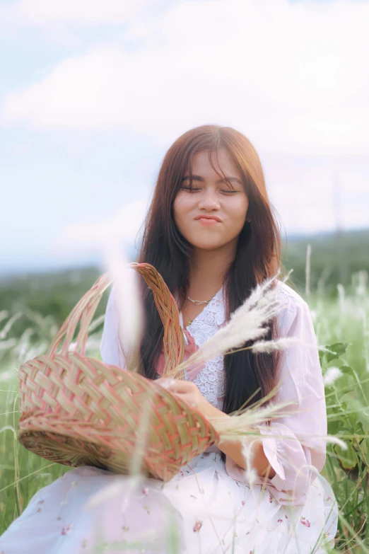 a girl in a dress holding an empty basket