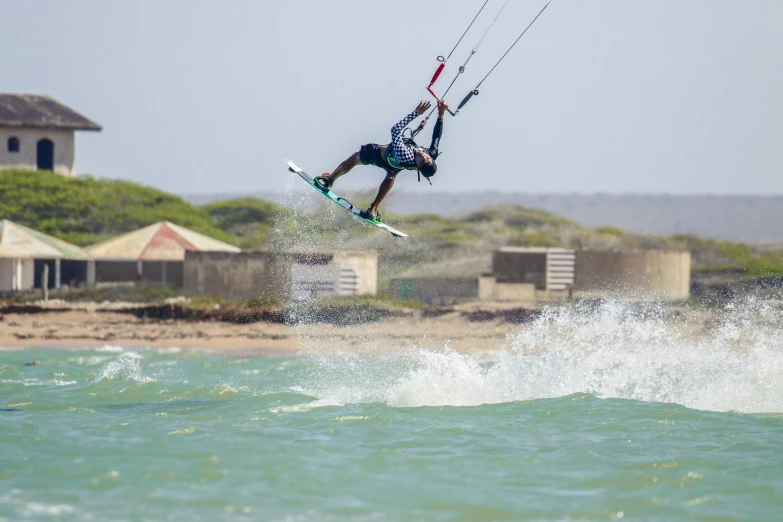 a man on surfboard in the air above water