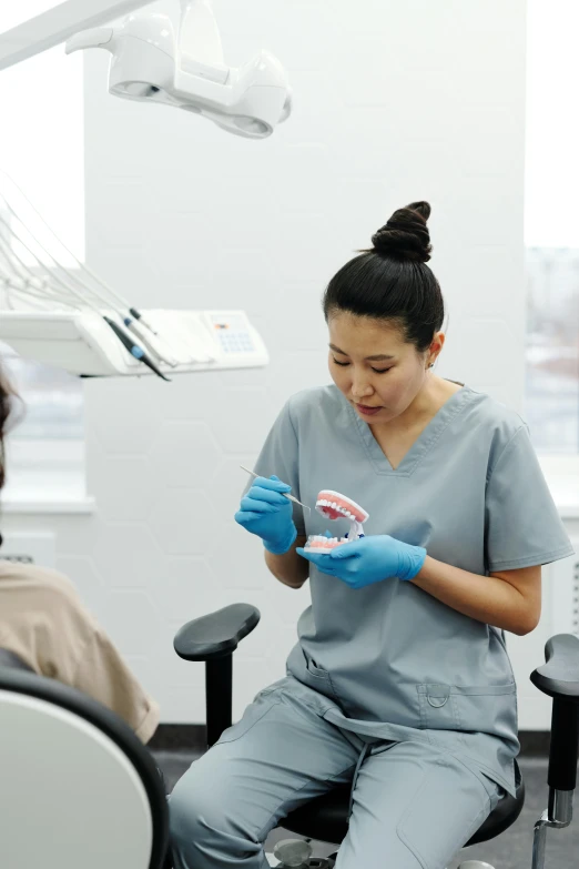 a person is sitting down with some blue gloves on