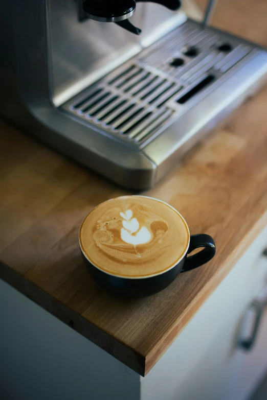 a cappuccino on the counter, with the machine in the background