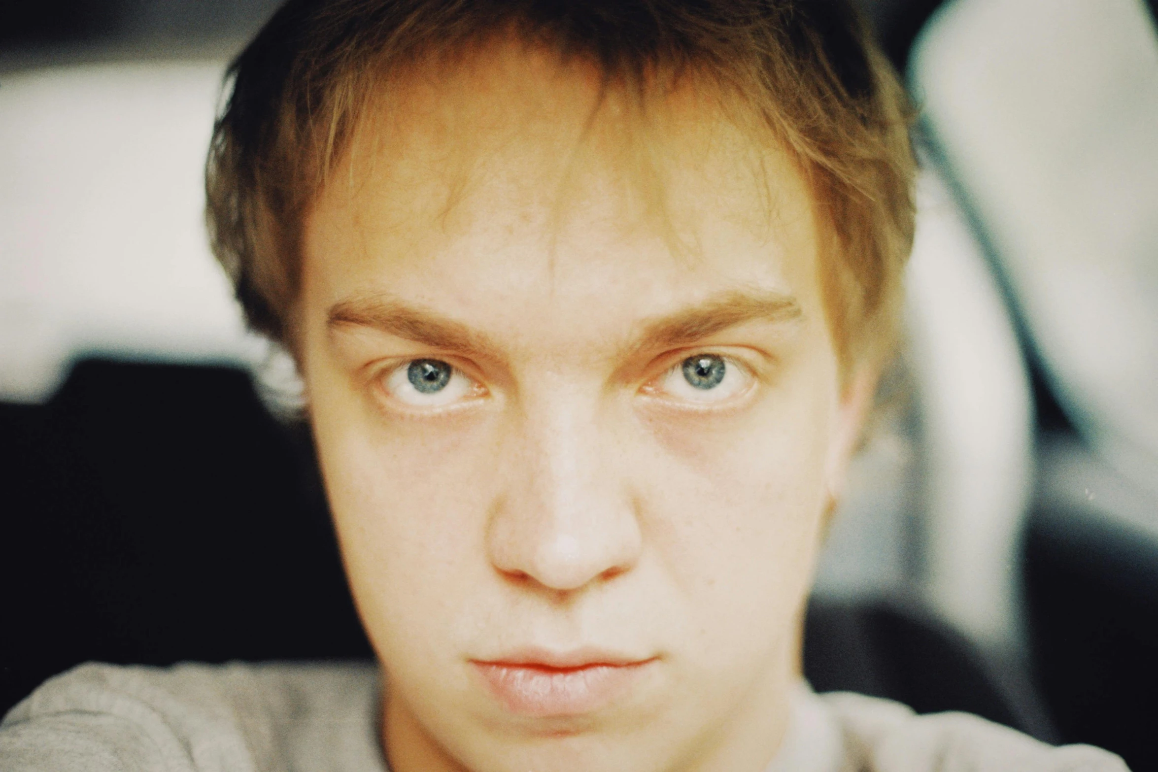 man staring into the camera with blue eyes