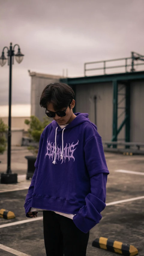 a person in a purple hoodie is standing