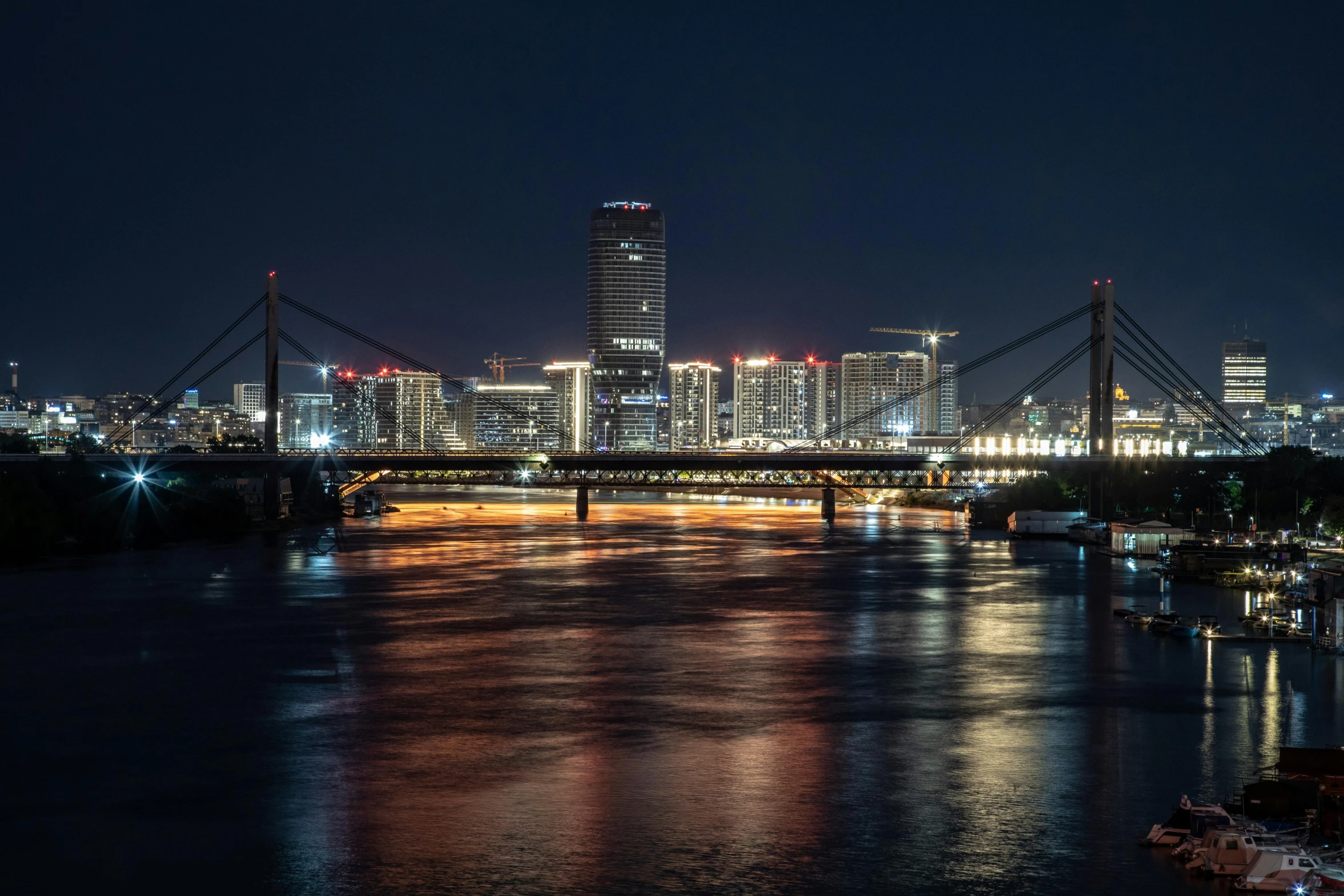 a view of the city at night from across the river