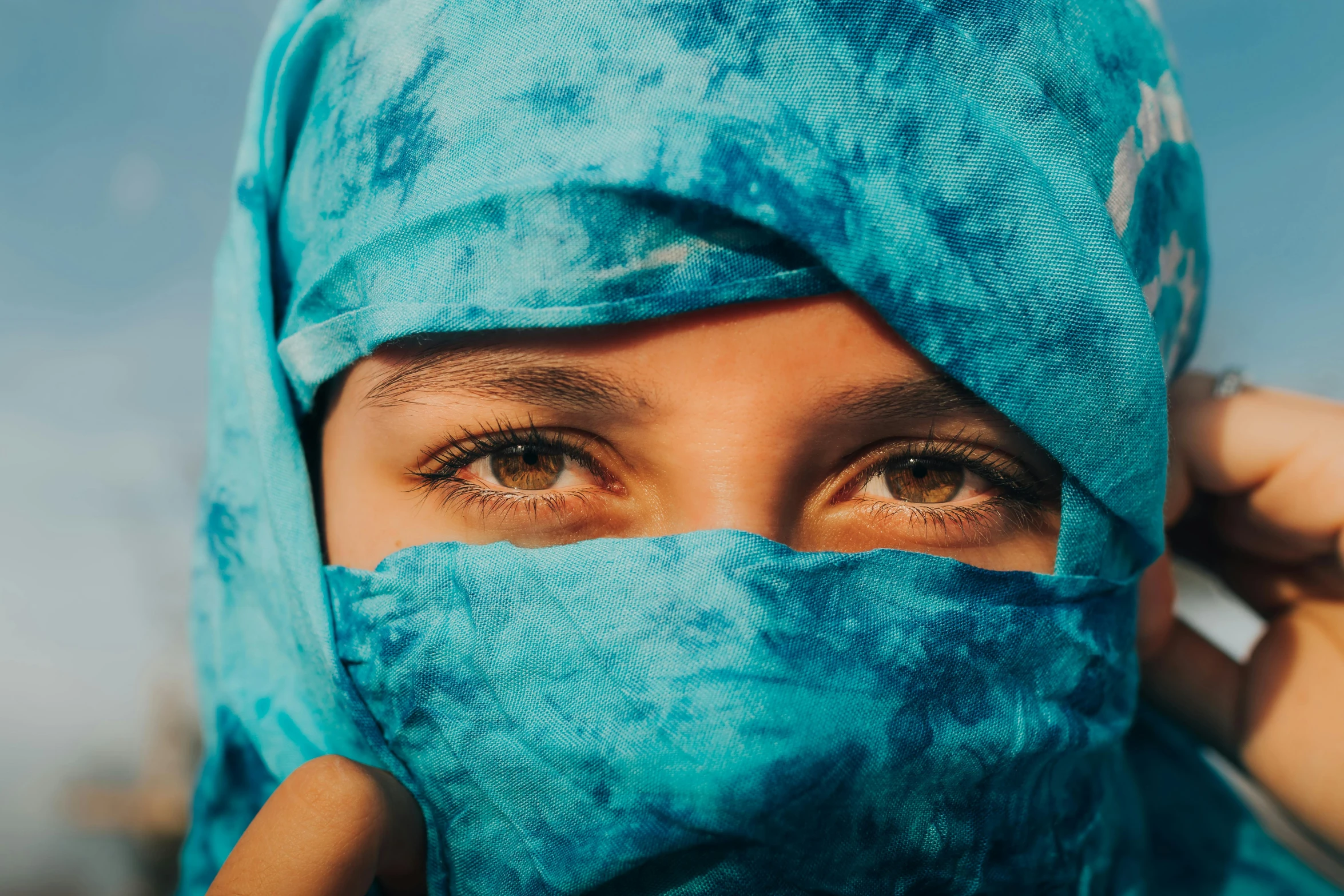 woman with a headscarf covering her face