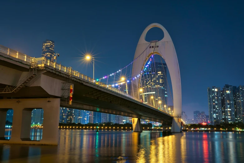 large white building at night near a bridge