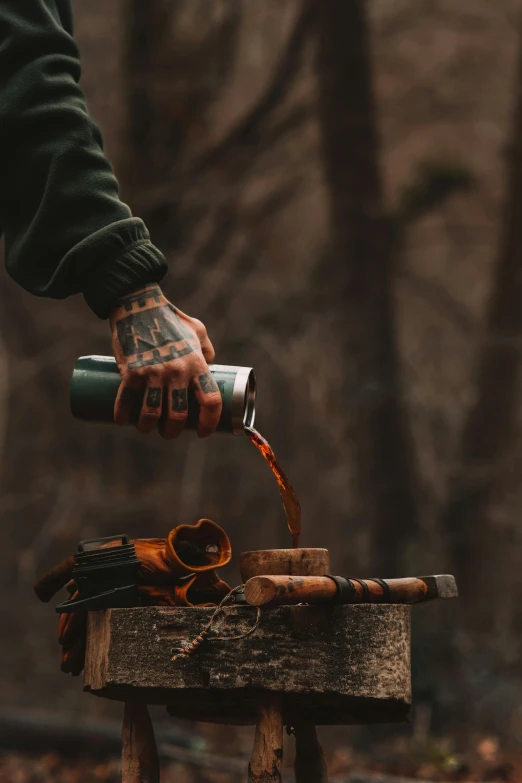 a hand holding soing over a piece of wood