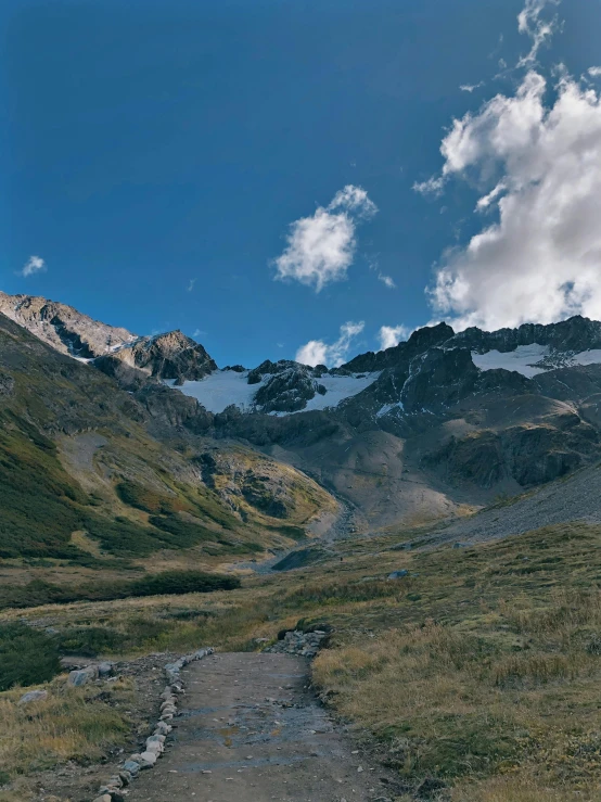 a winding trail in a mountain area on a sunny day