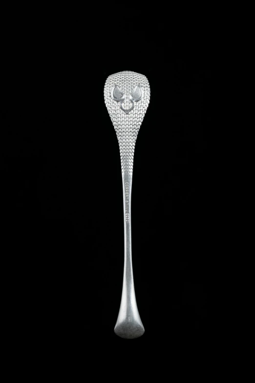 a large crystal spoon with diamonds in it