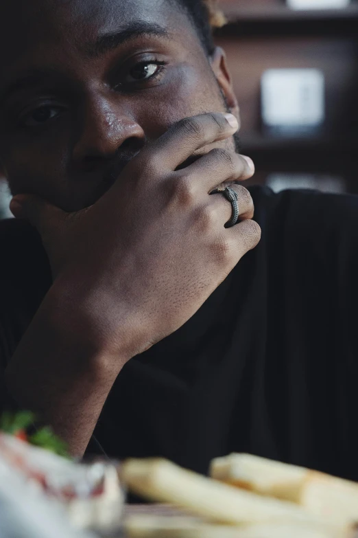 a man with his chin resting in his hands looking straight ahead